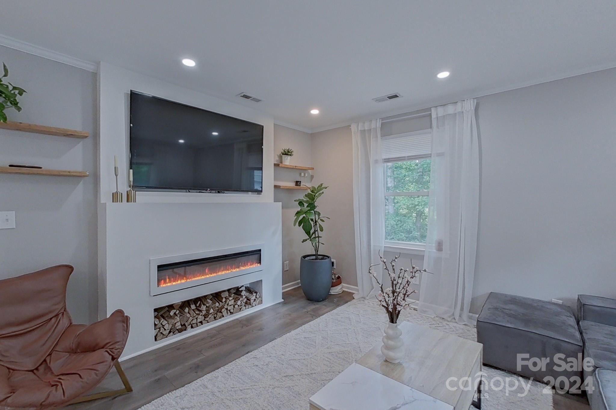 202 Smith Street Locust, NC 28097 - Photo 8 of 42 a living room with furniture a window and a flat screen tv