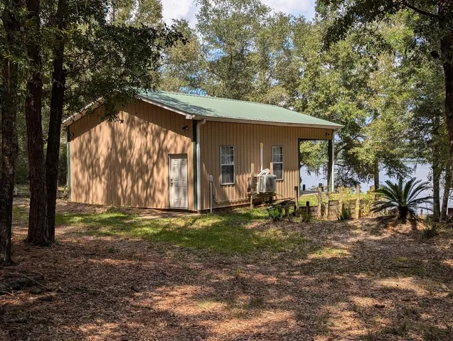 a view of a house with backyard porch and sitting area