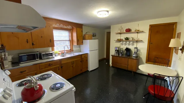 a kitchen with a refrigerator and a stove