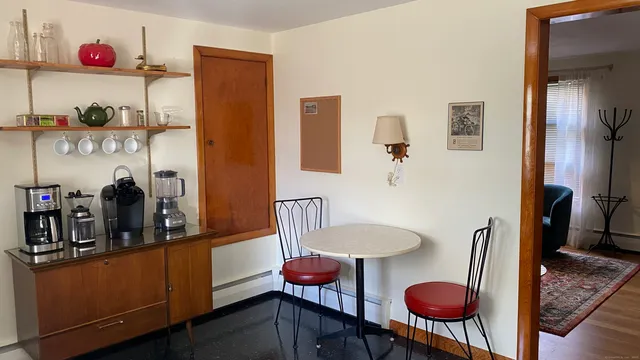 a kitchen with a refrigerator and wooden floor