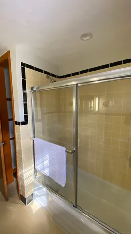 a bathroom with a shower and a tub
