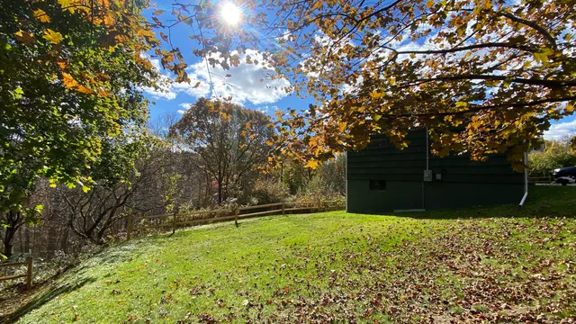 a view of house with yard