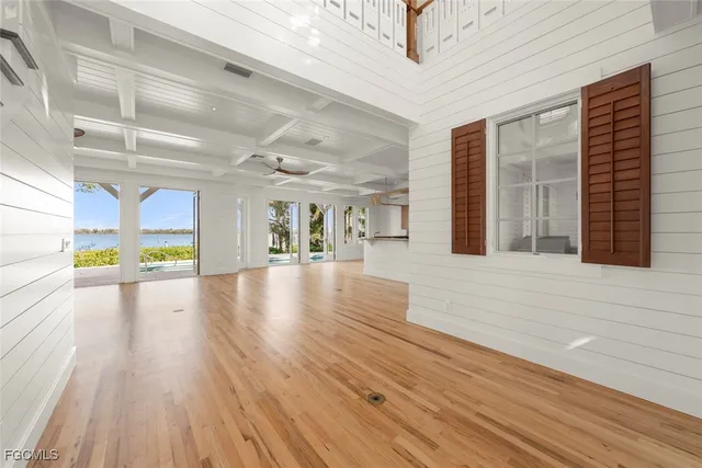 a bedroom with a large bed and a wooden floor