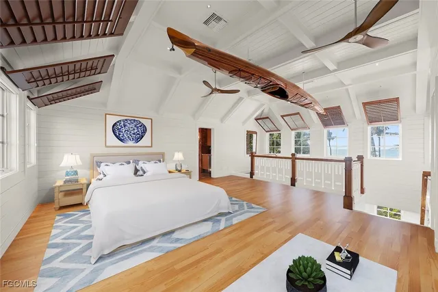 a bedroom with furniture and wooden floor