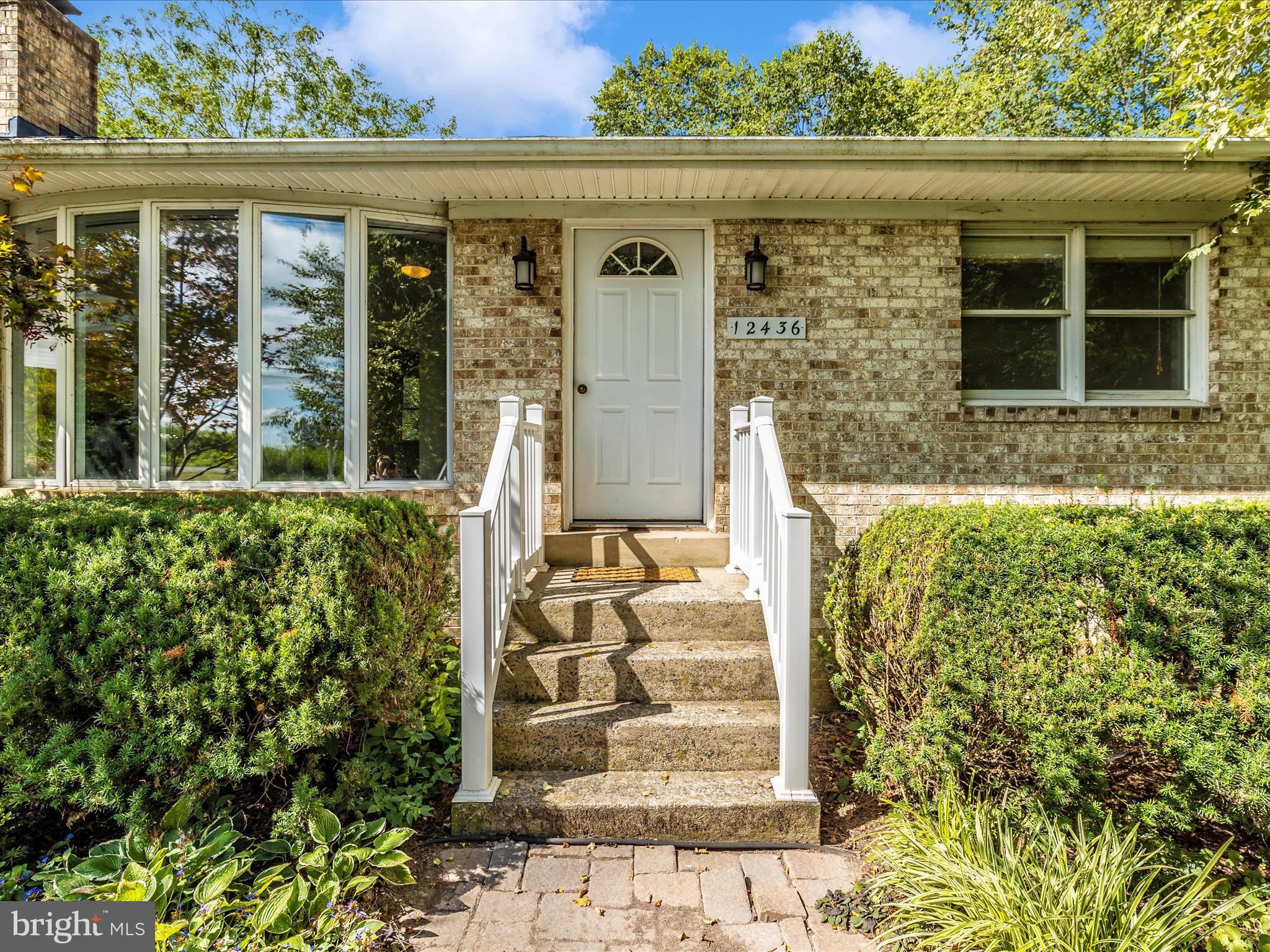 12436 Legore Road Keymar, MD 21757 - Photo 14 of 72 front view of a brick house with large windows