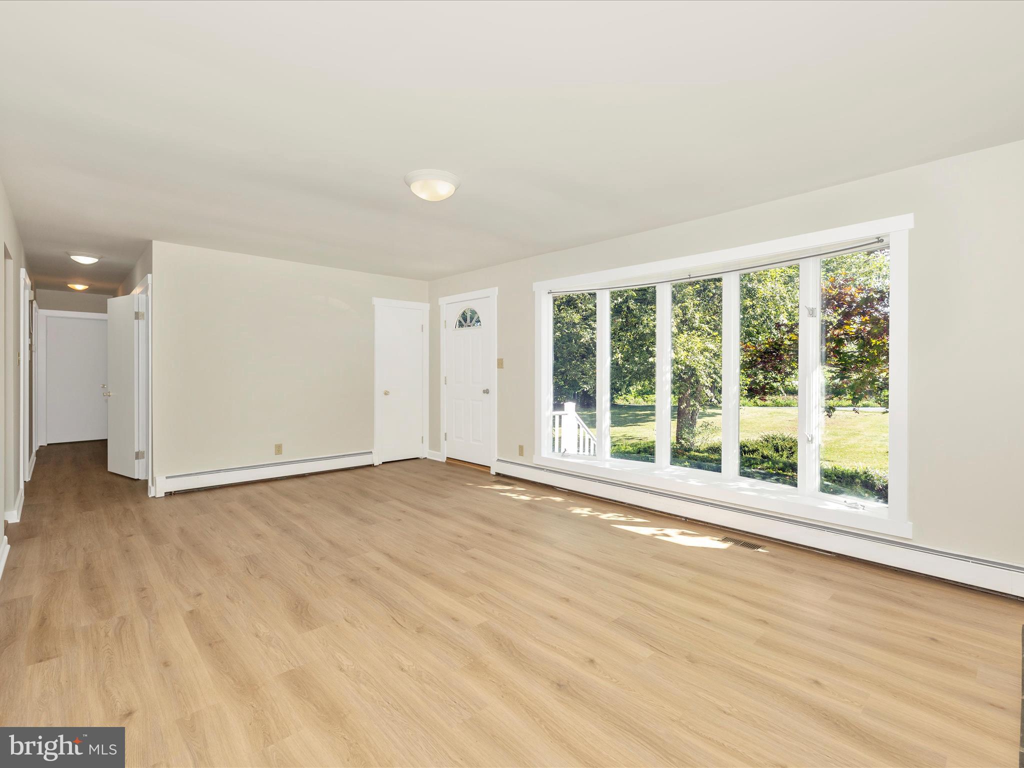 12436 Legore Road Keymar, MD 21757 - Photo 23 of 72 a view of an empty room with wooden floor and a window