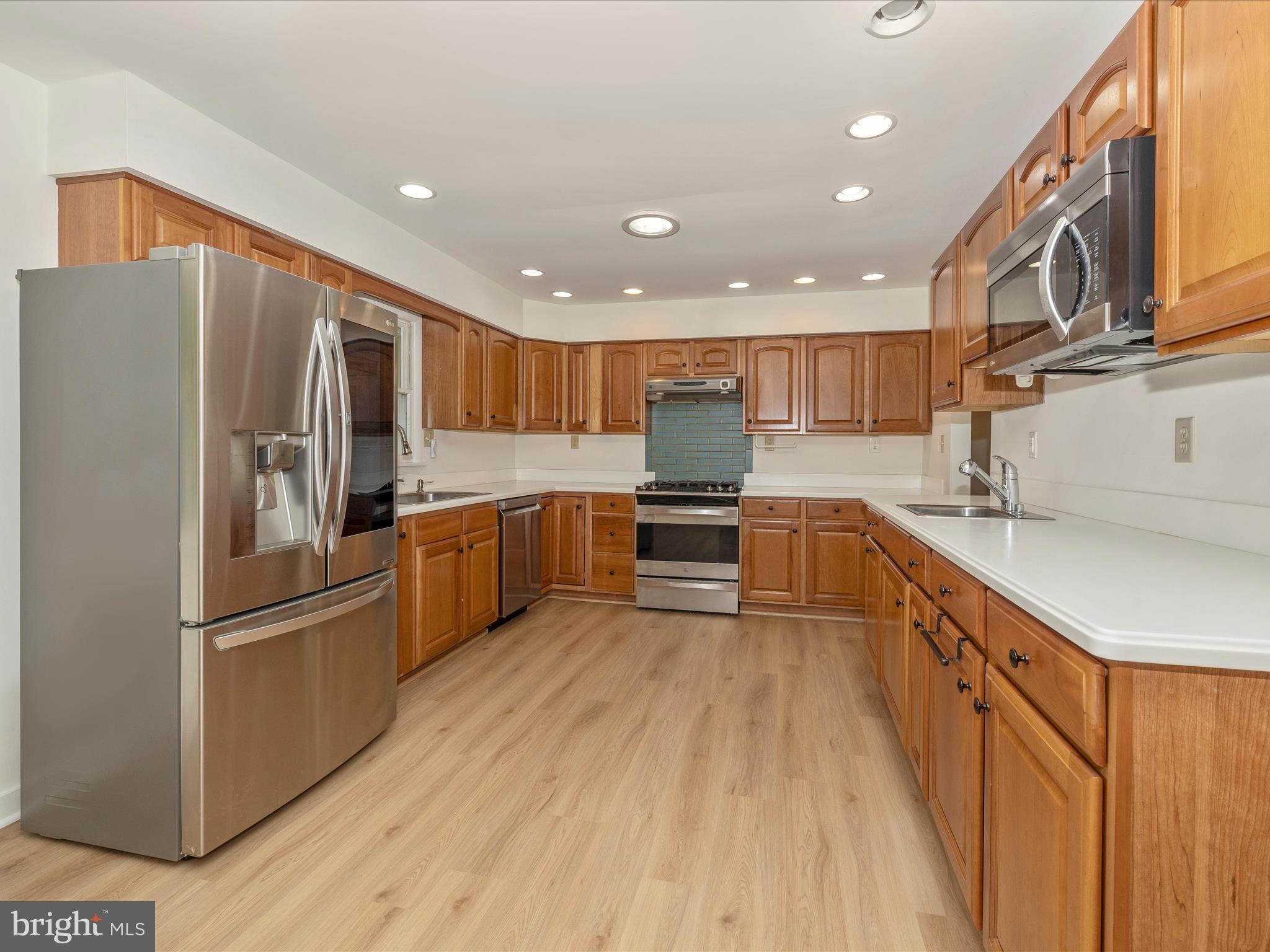 12436 Legore Road Keymar, MD 21757 - Photo 28 of 72 a kitchen with stainless steel appliances granite countertop a refrigerator oven a sink dishwasher and wooden cabinets with wooden floor