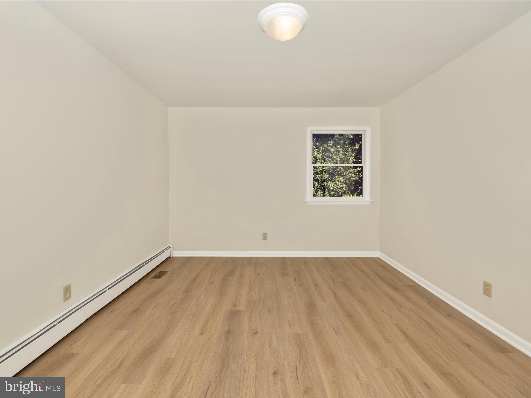 12436 Legore Road Keymar, MD 21757 - Photo 33 of 72 an empty room with wooden floor and windows