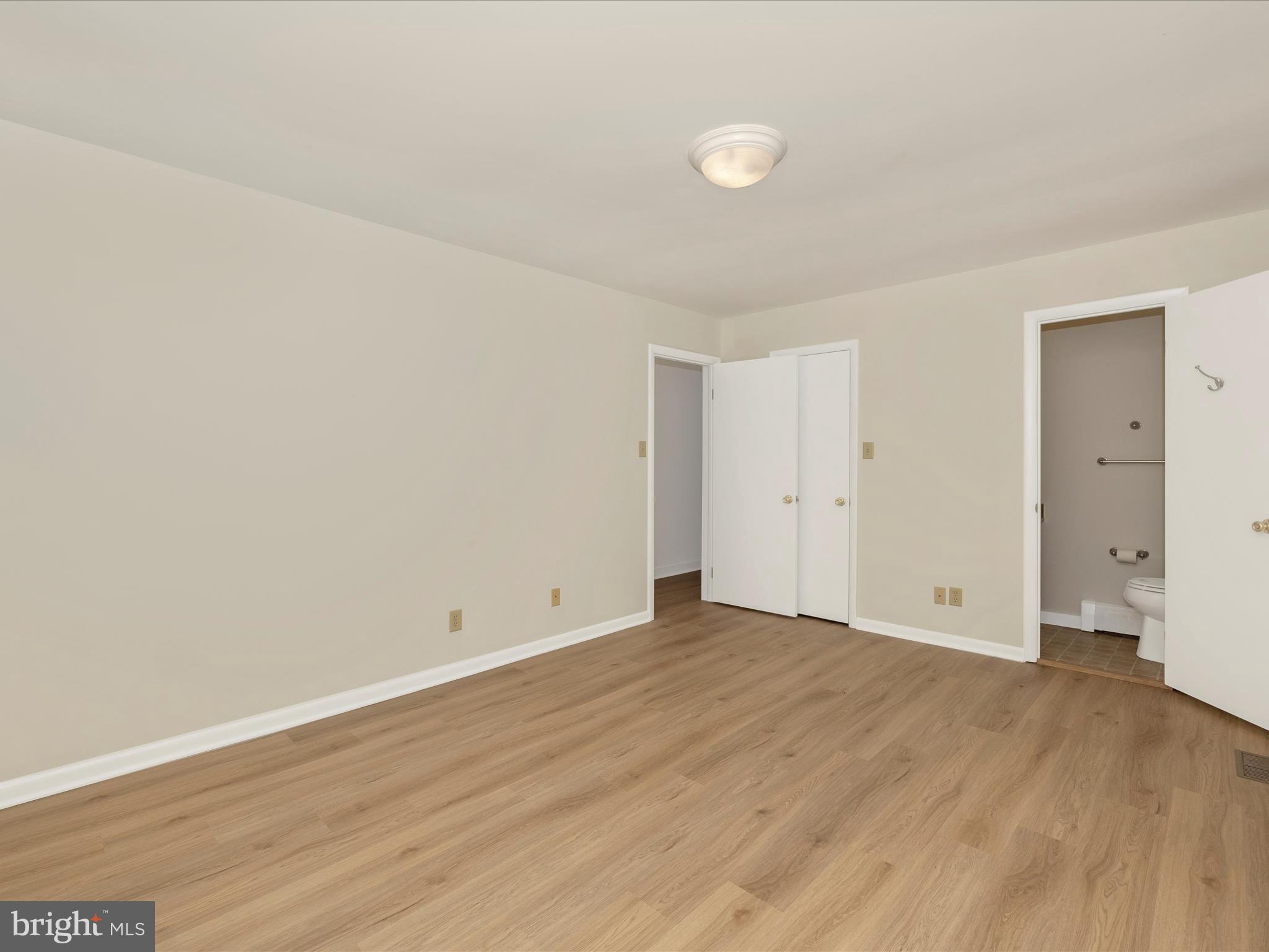 12436 Legore Road Keymar, MD 21757 - Photo 34 of 72 a view of an empty room with wooden floor and mirror