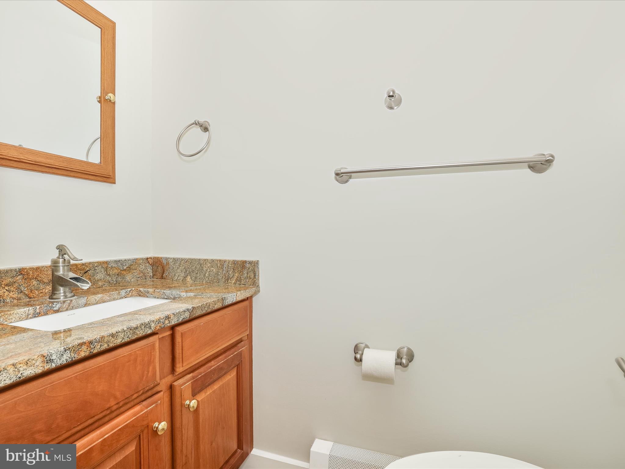 12436 Legore Road Keymar, MD 21757 - Photo 36 of 72 a bathroom with a granite countertop sink and a mirror