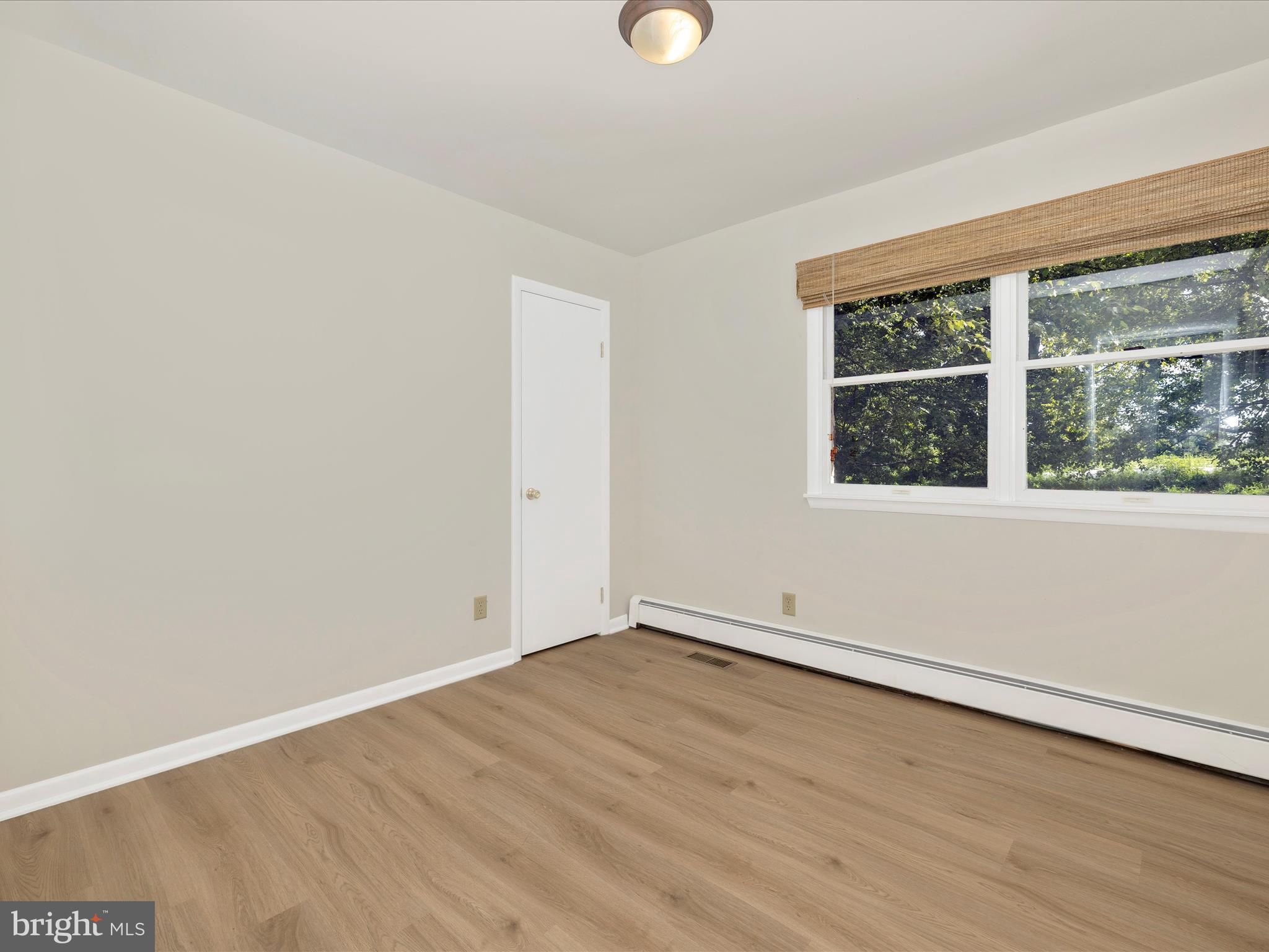12436 Legore Road Keymar, MD 21757 - Photo 39 of 72 an empty room with wooden floor and windows