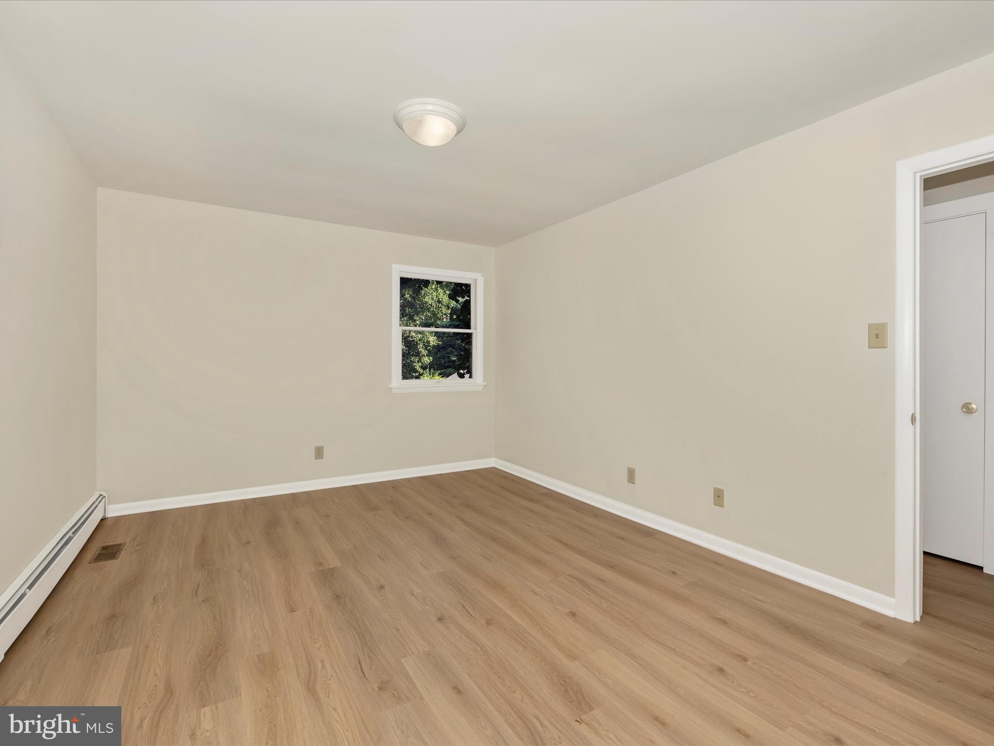 12436 Legore Road Keymar, MD 21757 - Photo 57 of 72 an empty room with wooden floor and windows