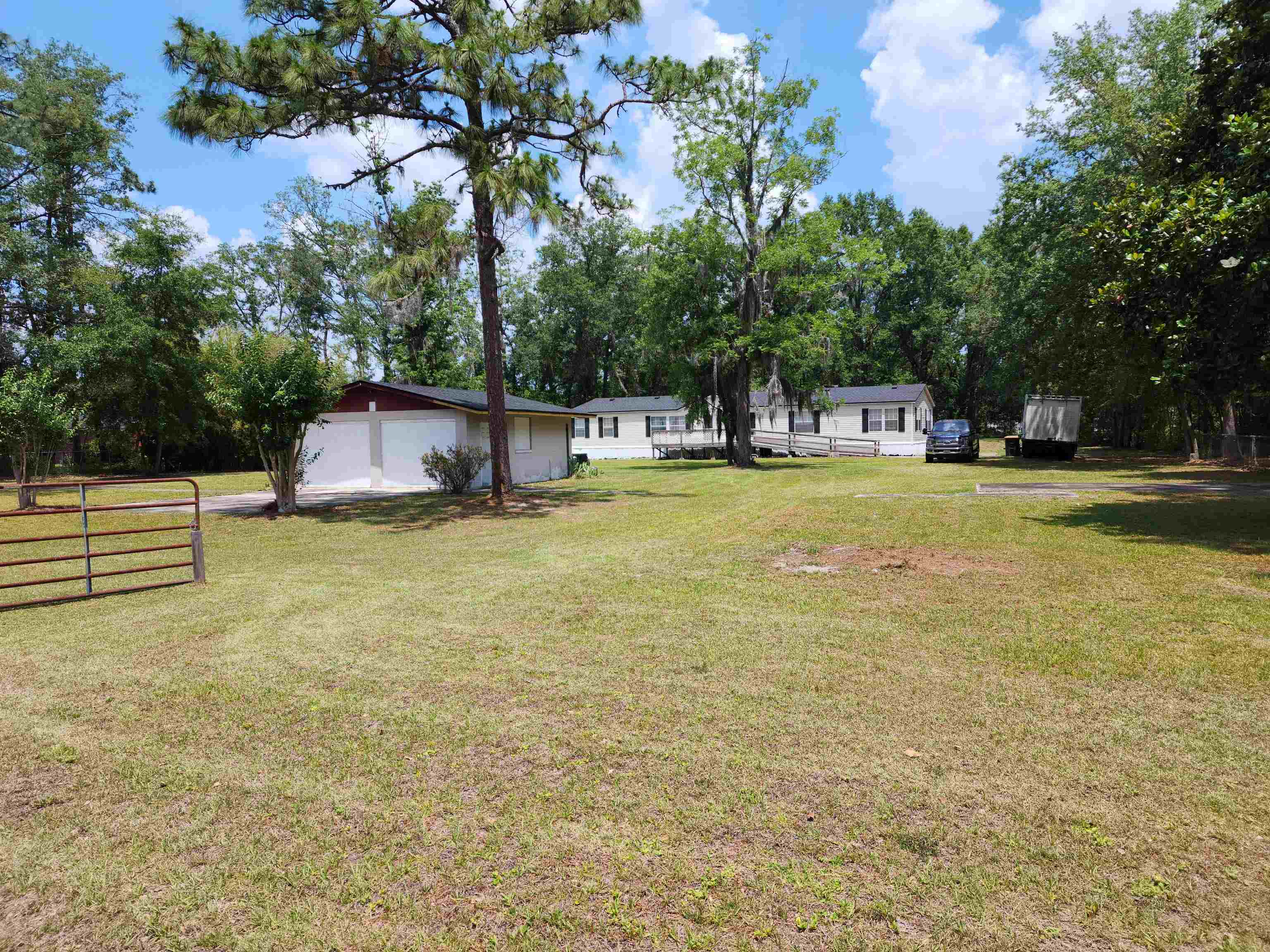 a house view with swimming pool in front of it