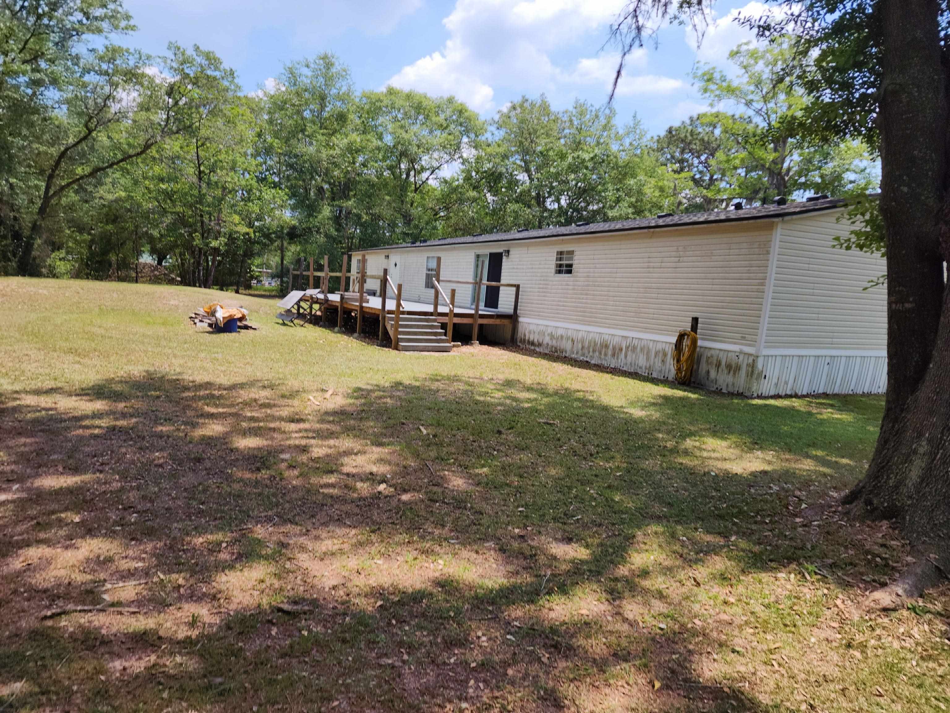 8431 Walden Road Jacksonville, FL 32244 - Photo 14 of 29 a backyard of a house with table and chairs