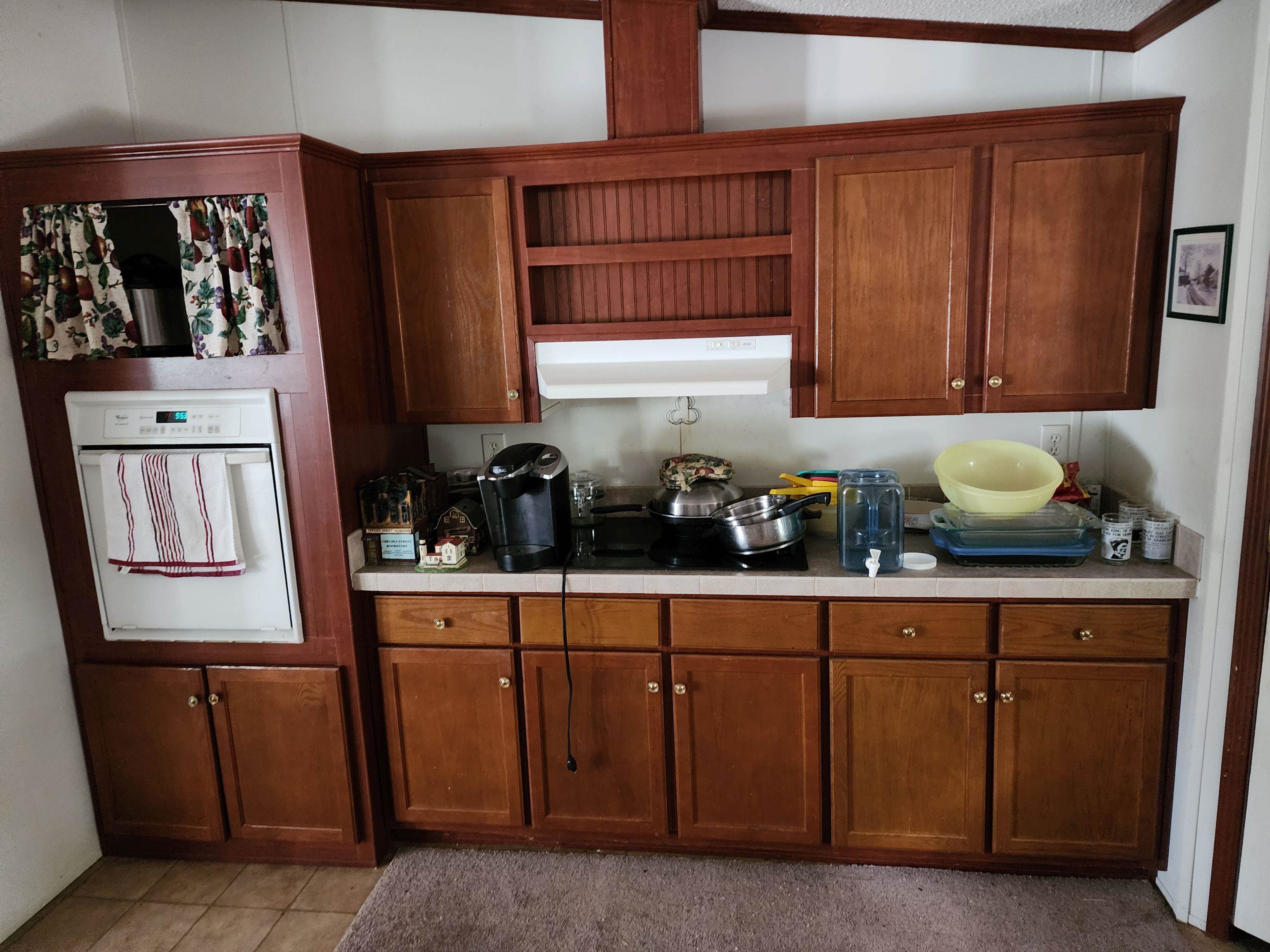 8431 Walden Road Jacksonville, FL 32244 - Photo 16 of 29 a kitchen with a sink a refrigerator and cabinets