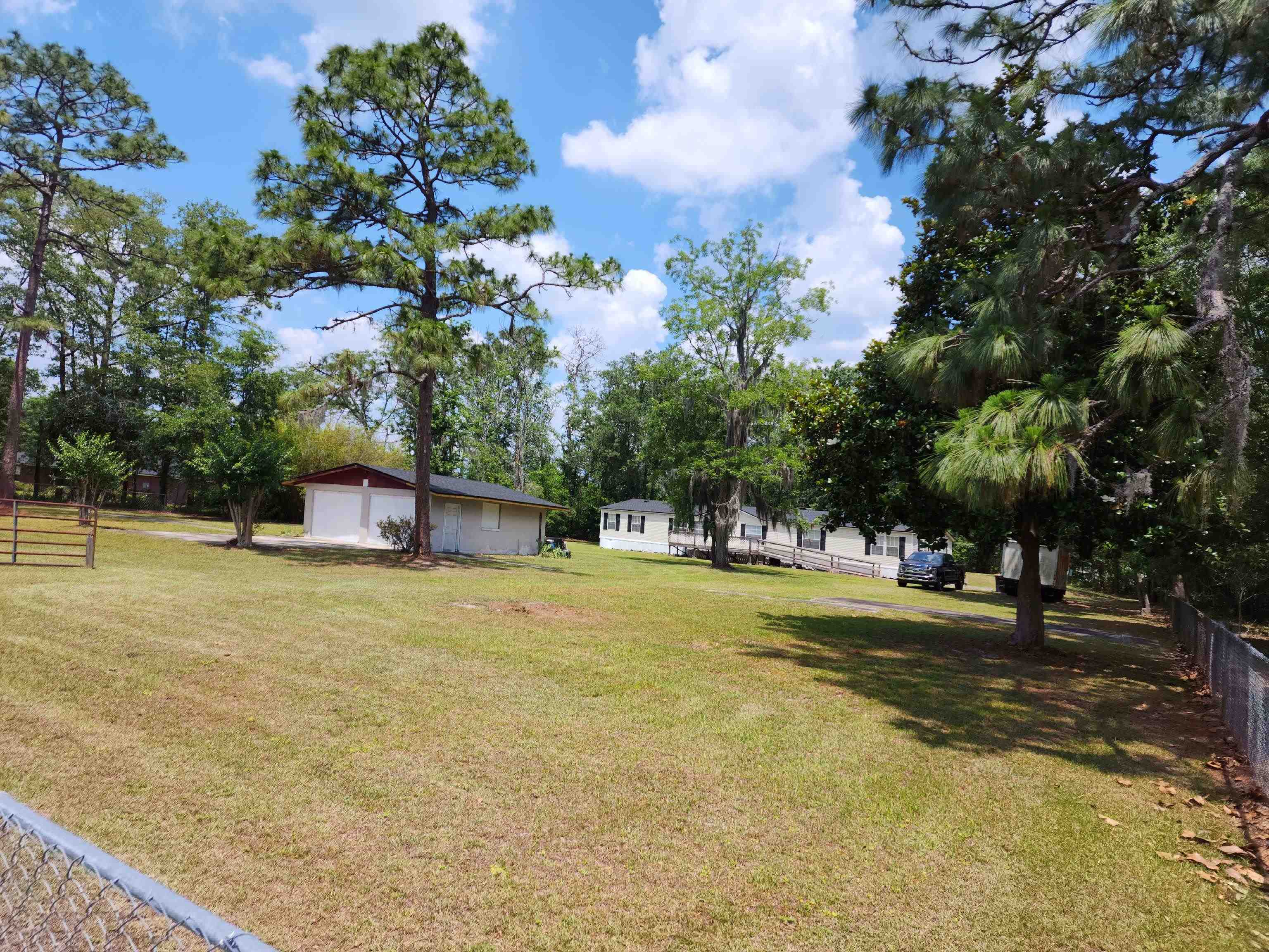 8431 Walden Road Jacksonville, FL 32244 - Photo 2 of 29 a yellow house with trees in front of it