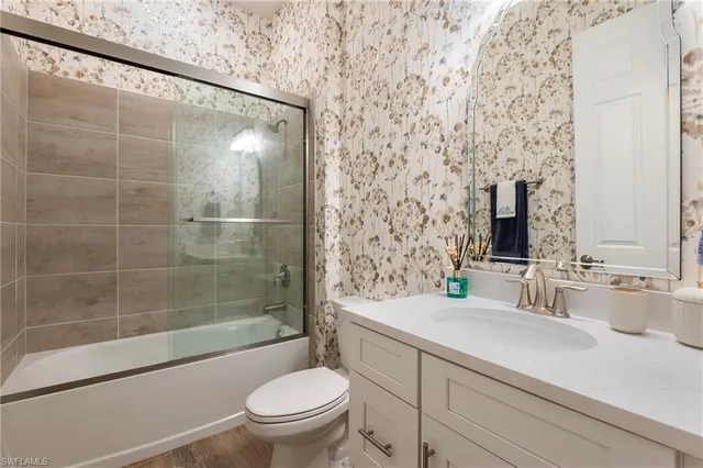 a bathroom with a sink mirror toilet and bathtub