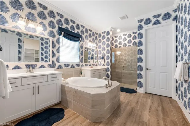 a bathroom with a tub sink and mirror