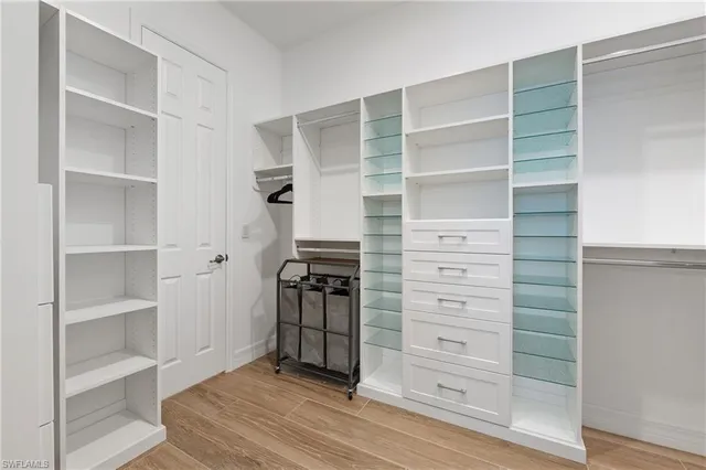 a view of walk in closet with empty racks