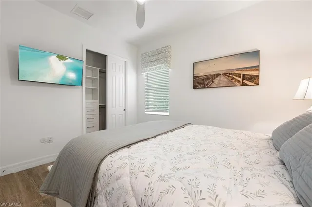 a bedroom with a large bed and a flat screen tv