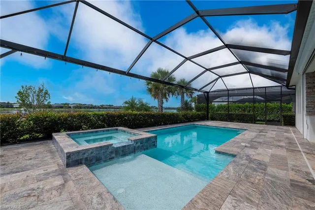 a view of a swimming pool with a patio and a yard