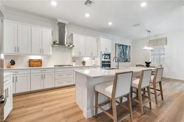 a kitchen with white cabinets and counter space