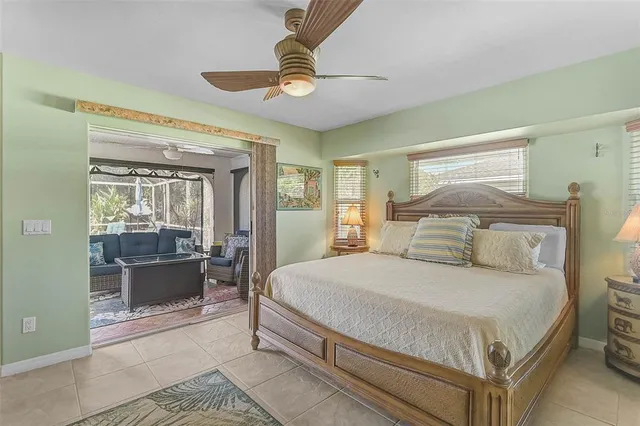 a bedroom with a large bed and a chandelier