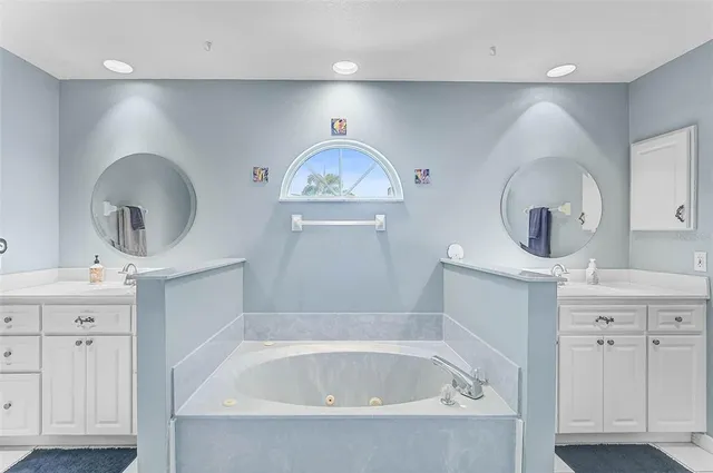a bathroom with a sink mirror and vanity