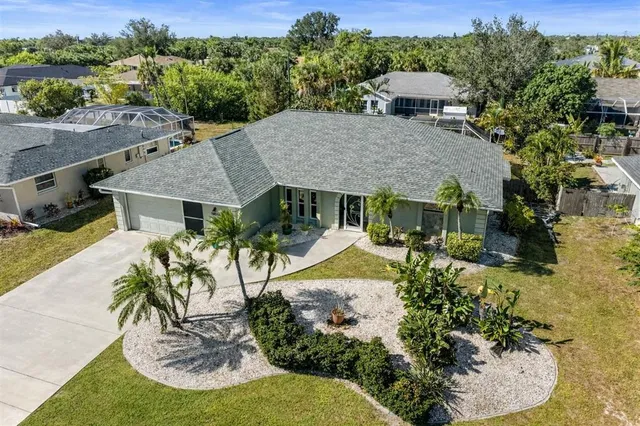 an aerial view of a house with swimming pool garden and patio