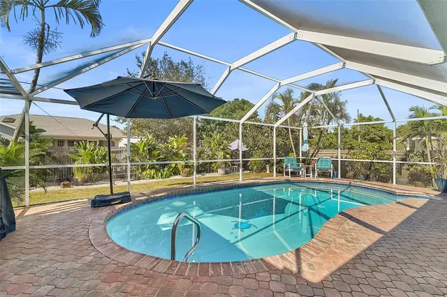 a view of a dining room with furniture a chandelier and wooden floor
