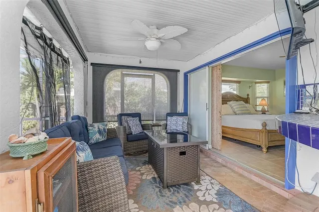 a living room with furniture and a book shelf