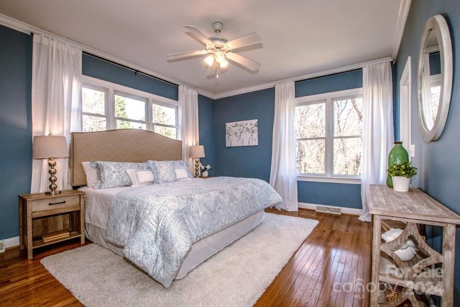 218 North Kimberly Road Davidson, NC 28036 - Photo 25 of 44 a bedroom with a large bed and a chandelier