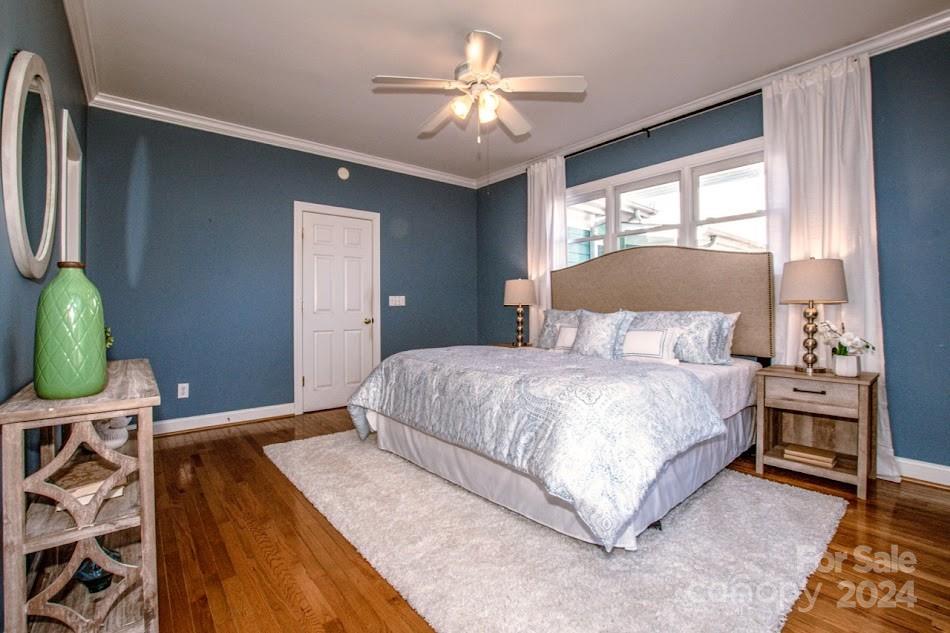 218 North Kimberly Road Davidson, NC 28036 - Photo 26 of 44 a bedroom with a bed and a chandelier