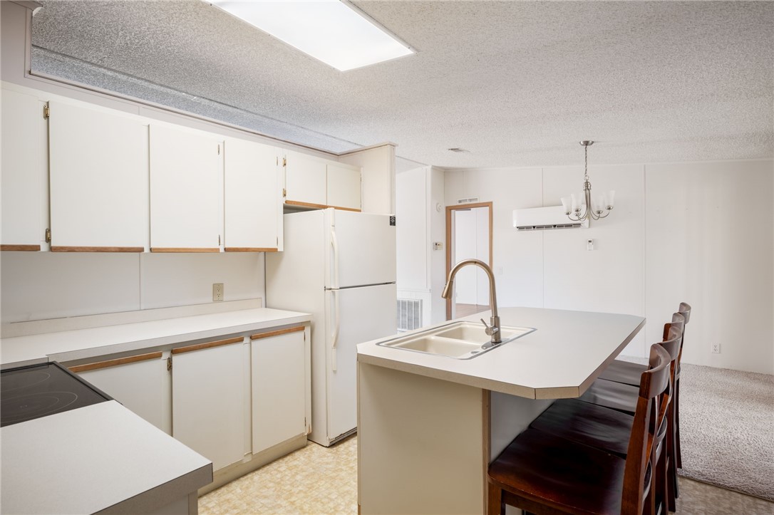 3836 13th Street Micco, FL 32976 - Photo 12 of 35 a kitchen with a sink a table and chairs