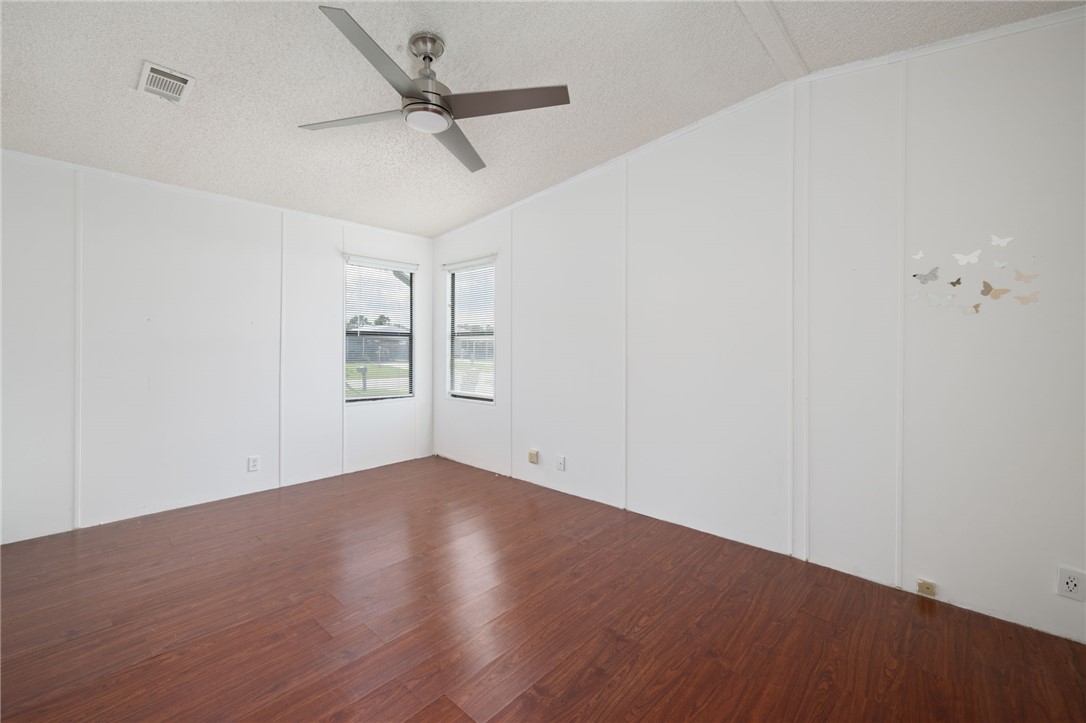 3836 13th Street Micco, FL 32976 - Photo 18 of 35 a view of empty room with wooden floor and ceiling fan
