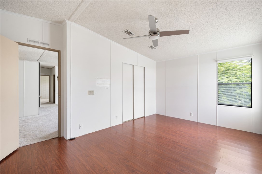 3836 13th Street Micco, FL 32976 - Photo 19 of 35 a view of an empty room with wooden floor and a window