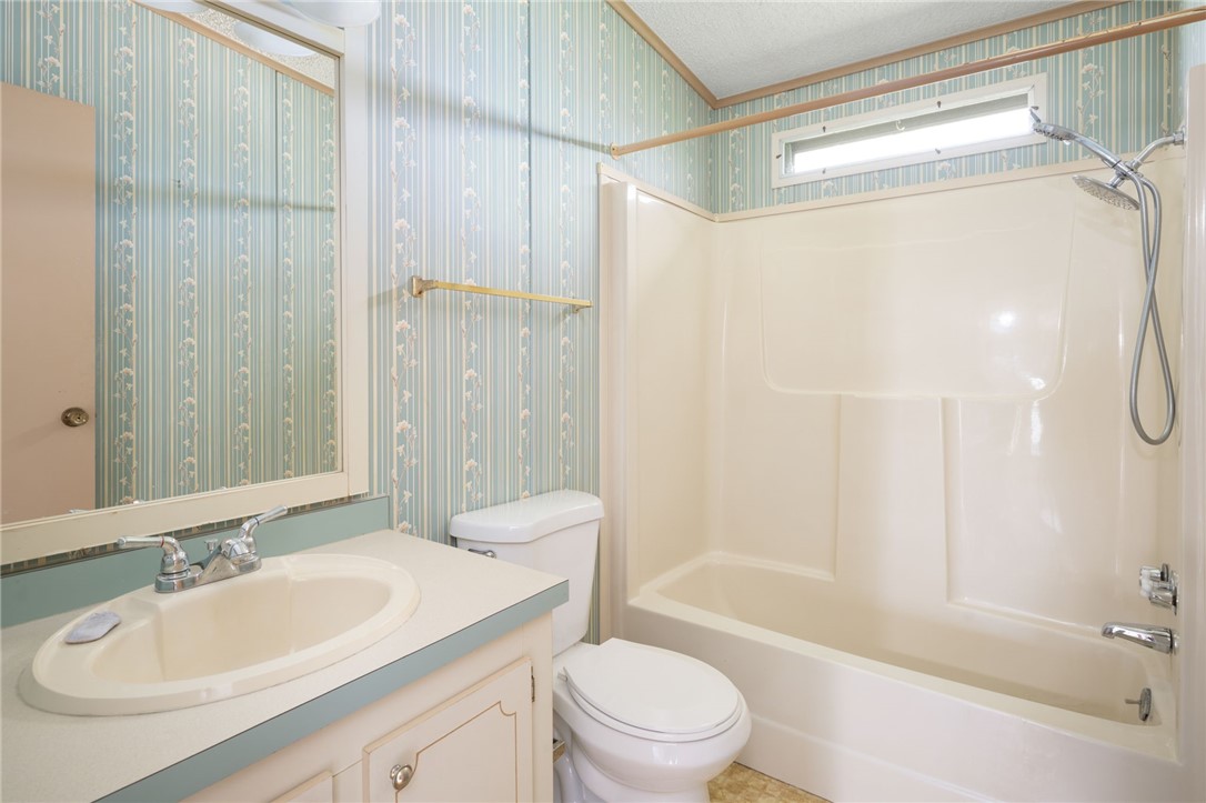 3836 13th Street Micco, FL 32976 - Photo 25 of 35 a bathroom with a sink a toilet and shower