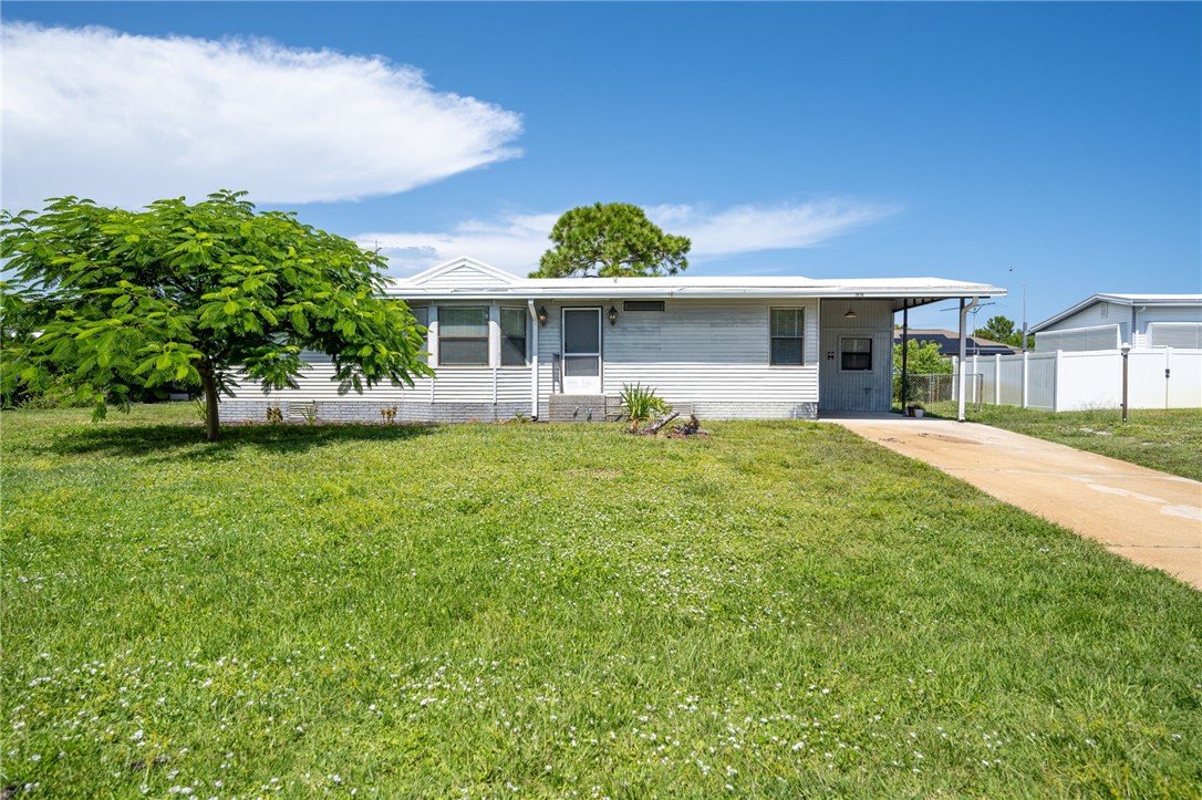 3836 13th Street Micco, FL 32976 - Photo 34 of 35 a front view of a house with garden