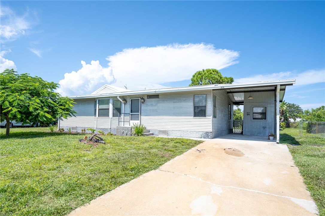 3836 13th Street Micco, FL 32976 - Photo 35 of 35 a front view of a house with a garden and yard
