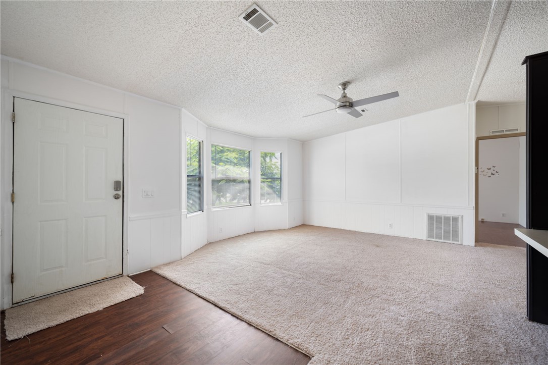 3836 13th Street Micco, FL 32976 - Photo 4 of 35 an empty room with windows and fan