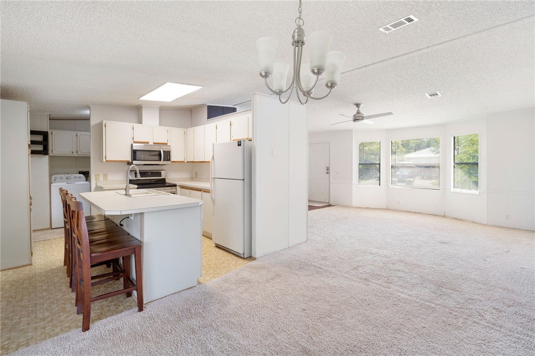 3836 13th Street Micco, FL 32976 - Photo 9 of 35 a view of kitchen with sink microwave and refrigerator