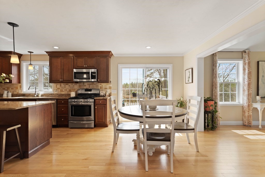 360 Richardson Road Dracut, MA 01826 - Photo 8 of 25 a kitchen with a stove a sink and a refrigerator