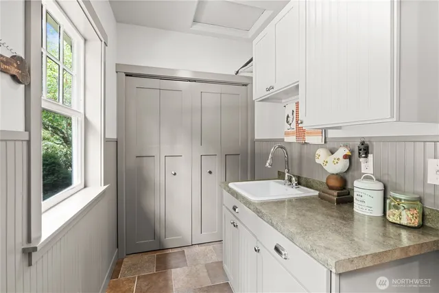 a kitchen with a refrigerator and a sink