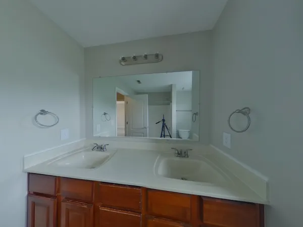 a bathroom with a sink and two mirror