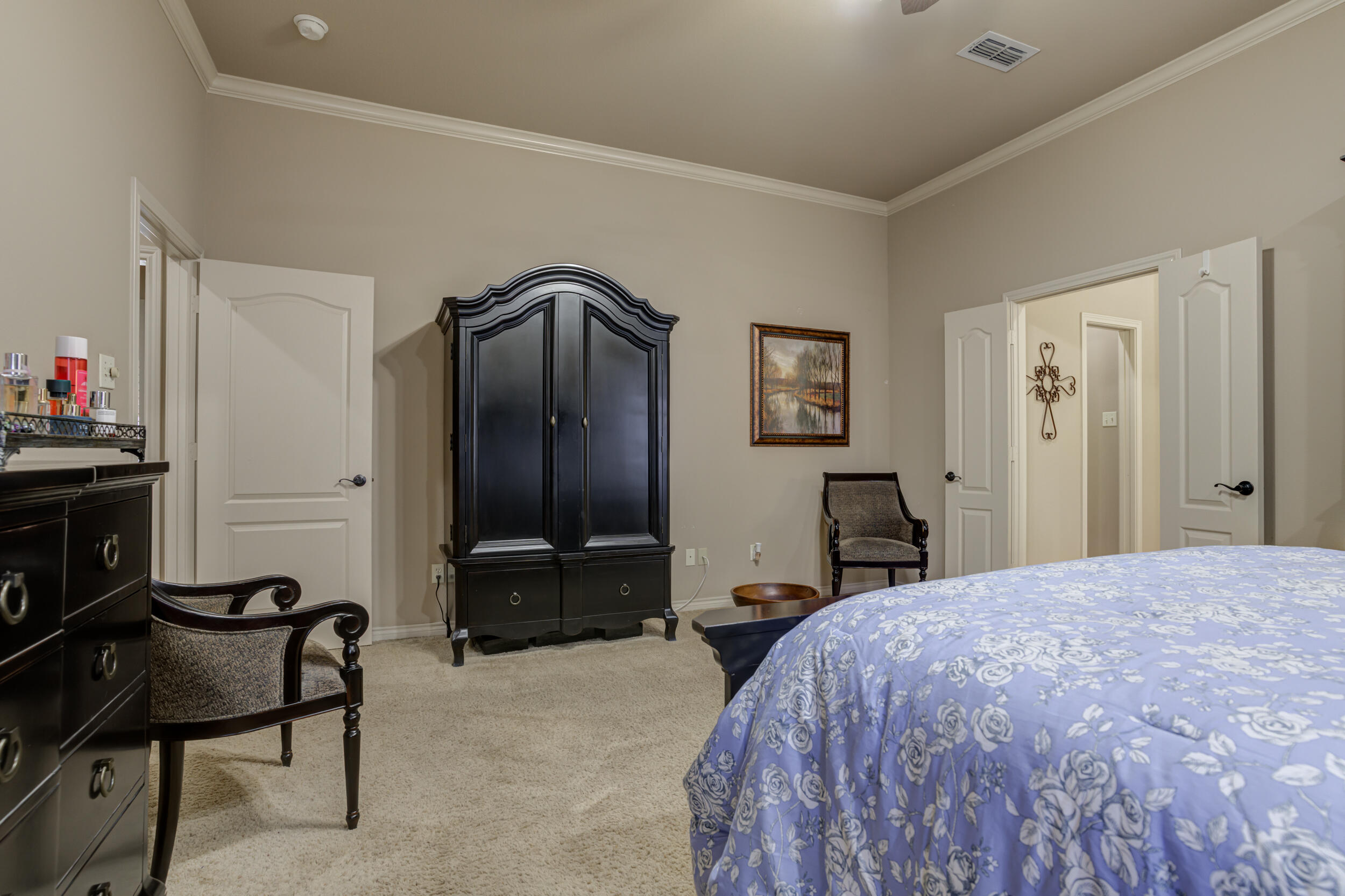 6008 89th Street Lubbock, TX 79424 - Photo 28 of 61 a bedroom with a bed and a chair