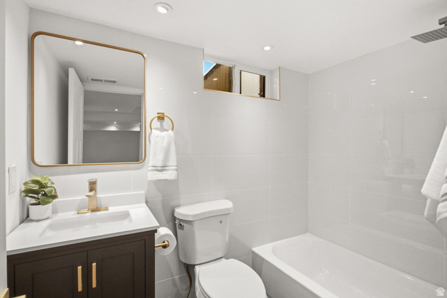 1187 East Ridgedale Circle Millcreek, UT 84106 - Photo 25 of 49 Bathroom featuring a modern vanity with dark wood-finish cabinetry, a white countertop, and gold-tone fixtures