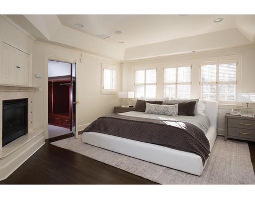 131 Laurel Road Brookline, MA 02467 - Photo 12 of 22 a spacious bedroom with a bed and a fireplace