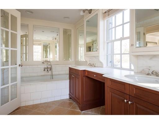 131 Laurel Road Brookline, MA 02467 - Photo 13 of 22 a bathroom with a sink a vanity a mirror and a bathtub