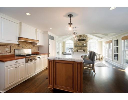 131 Laurel Road Brookline, MA 02467 - Photo 8 of 22 a kitchen with kitchen island granite countertop a sink cabinets and wooden floor