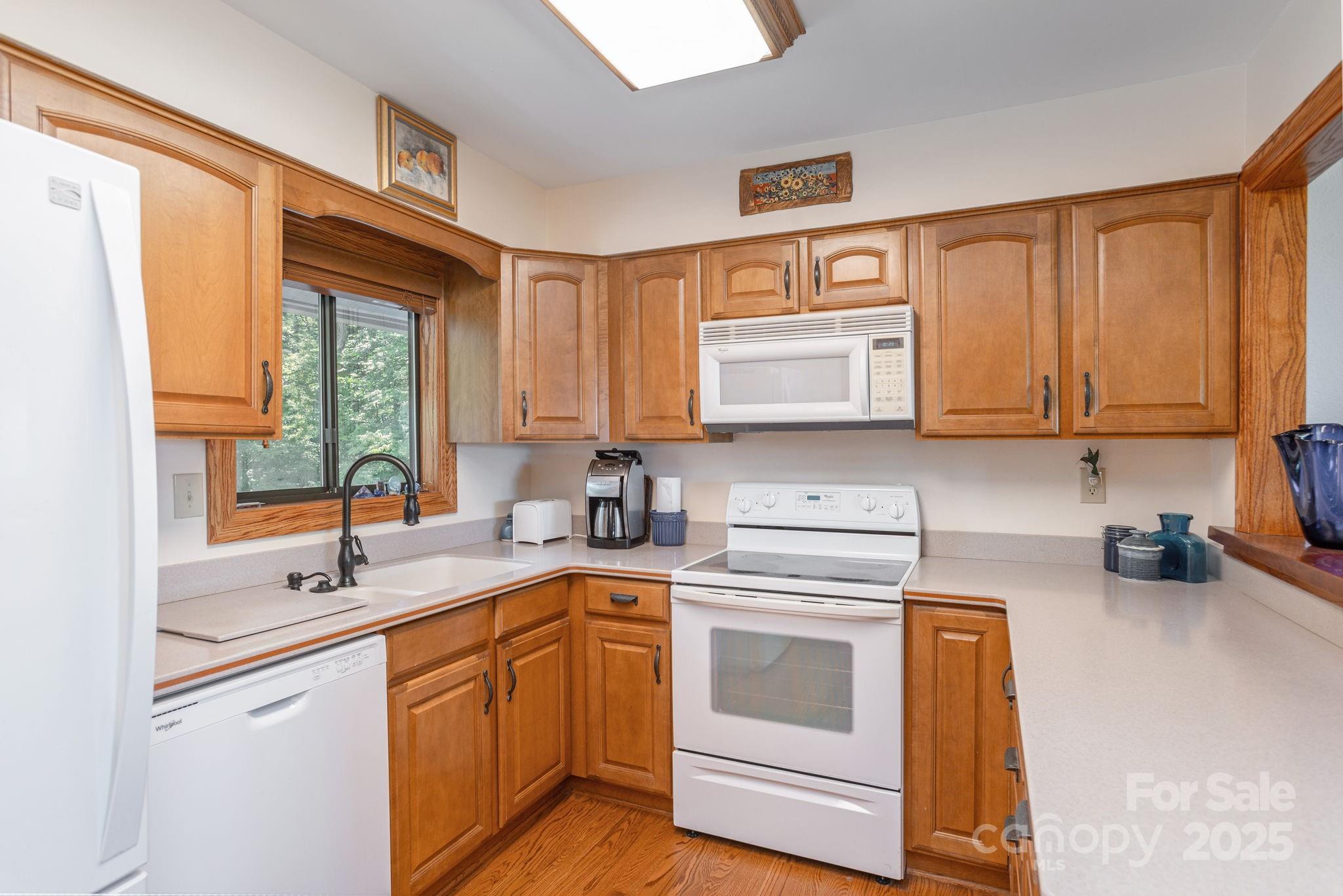 524 Three Mile Knob Road, Unit 3 Pisgah Forest, NC 28768 - Photo 21 of 33 a kitchen with stainless steel appliances granite countertop a sink a stove and cabinets